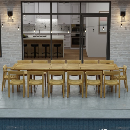 70353 Laguna 15 pc Teak Dining Set of 14 dining armchair and rectangular 11 foot extendable dining table angled side view in front of glass doors in the background 