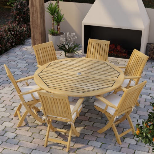 70357 Vogue Barbuda 7 pc Dining Set angled aerial view of table top on brick paver patio in front of an outdoor fireplace and landscape plants in background