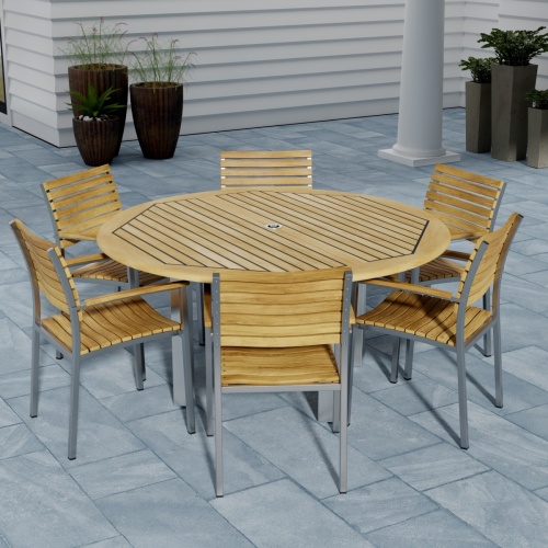 70442 Vogue Teak 7 pc Dining Set showing Vogue 60 inch Round Dining Table and 6 Dining Chairs side view on patio with window and fence with trees in background