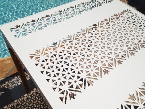 70448 Bloom 32 inch square teak and powder coated aluminum dining table aerial closeup view of table top on paver patio with pool in background