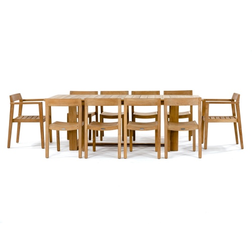 70457 Horizon 11 pc Teak Dining Set of Horizon Rectangular Teak DIning Table and 2 Teak Dining Armchairs and 8 Teak Side Chairs side angled on patio with hillside and ocean background
