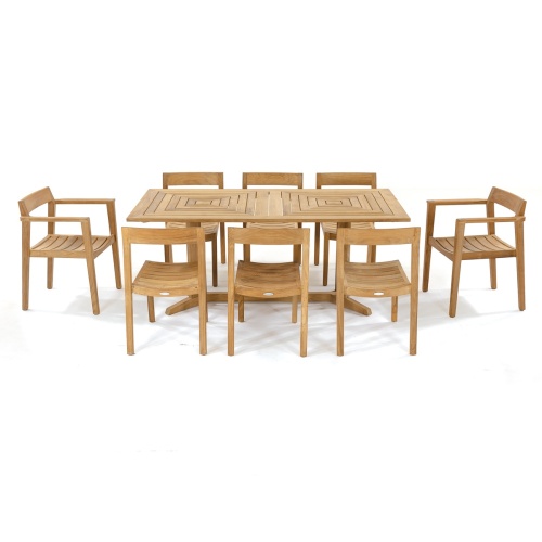 70462 Pyramid Horizon 9 pc Teak Dining Set of Pyramid Rectangle Dining Table and 2 Horizon Dining Armchairs and 6 Side Chairs in angled side view on patio with landscape plants in background