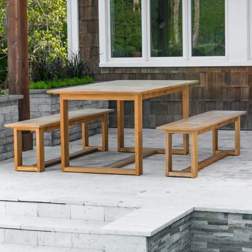 70497 Horizon teak Picnic Dining Set on outdoor deck with paver planters with landscape plants with grass and shrubs in background