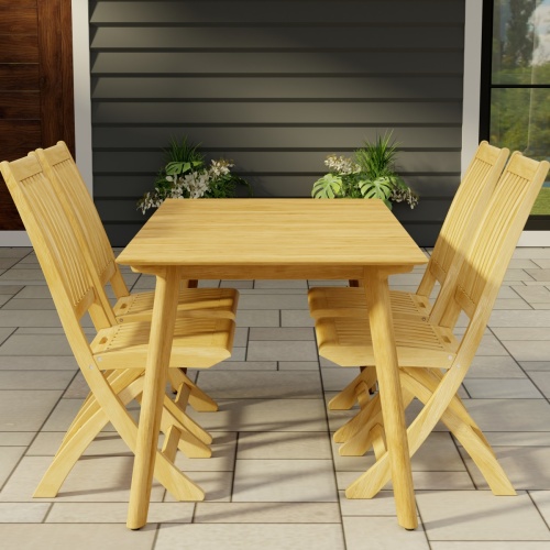 70562 Surf Barbuda Teak 5 pc Dining Set of Surf 5 ft Rectangular Table and 4 Barbuda Folding Side Chairs end view on patio with 2 potted plants and a door and window of house in the background