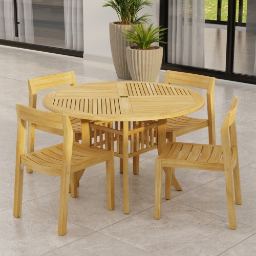 70573 Grand Hyatt Horizon Dining Set of Grand Hyatt 48 inch Round Dining Table and 4 Teak Horizon Dining Side Chairs on patio with potted plants and glass door in background  