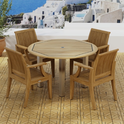 70620 Vogue Laguna Dining Set in angled side view on teak parquet tiled terrace next to potted plant overlooking Mediterranean hillside homes and ocean in background