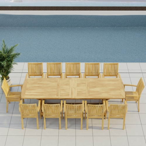 70757 Sussex Veranda 13 pc Teak Dining Set of Grand Veranda Rectangular Extending Dining Table and 12 Sussex Stacking Chairs in angled aerial side view on patio in front of a pool 