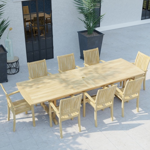 70759 Sussex Veranda 9 pc Teak Patio Dining Set of Sussex Dining Table and 8 Veranda Dining Chairs in angled aerial view on pool deck with house and windows and 2 potted plants in background 