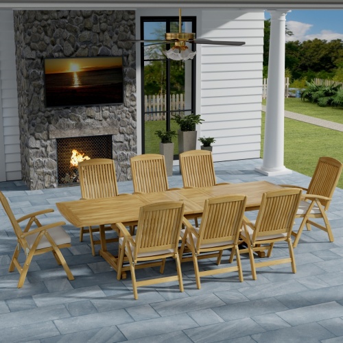 70796 Teak 9 piece Reclining Dining Set in angled side view on slate tiled patio in front of a fireplace with a door and window of house in background