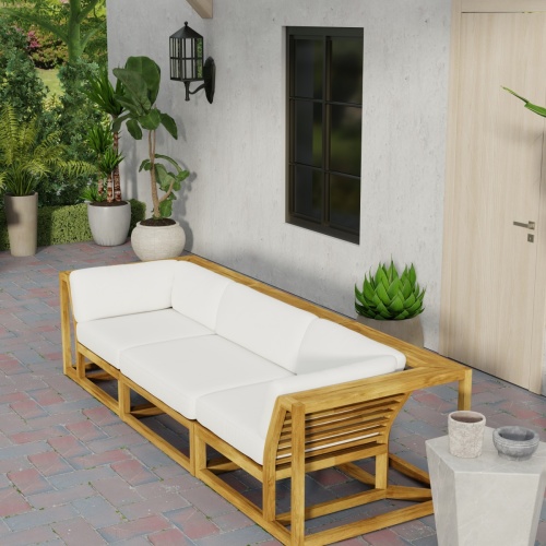 70818 Maya 3pc Deep Seating Sofa of 2 Maya Corner Sectionals and 1 Slipper Chair in angled front view on brick patio with 2 potted plants and windows and door to house in background