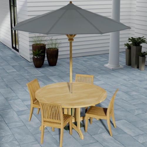 70851 Barbuda Laguna 5 pc Dining Set of Barbuda Folding Teak Table and 4 Laguna Side Chairs angled corner view on stone patio with 2 doors and a lit fireplace in the background
