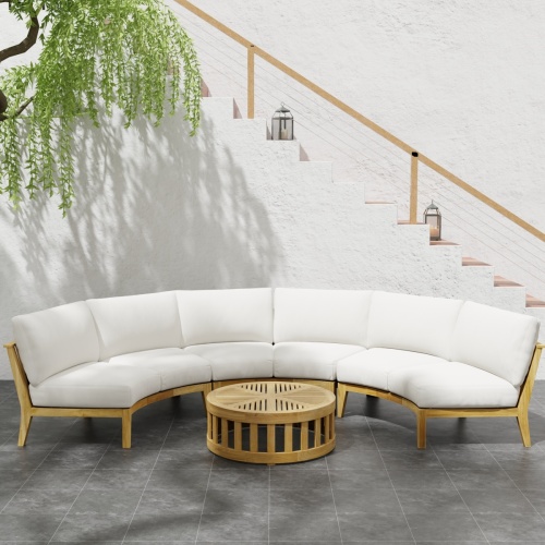 70869 Kafelonia 4 pc Round Sofa Set of 3 Kafelonia Sofa Sectional Benches and 36 inch round Coffee Table in angled top view next to potted plant on tiled patio in front of staircase 