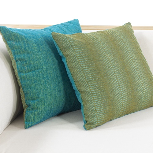 71005pepta electric treetop closeup view of two throw pillows in corner side of sectional sofa on white background
