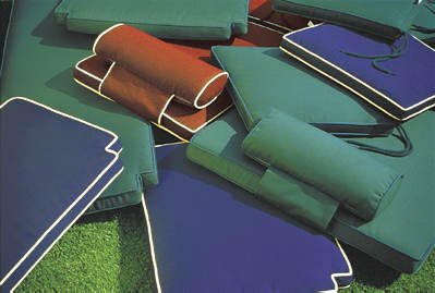72569MTO Navy Blue color cushions and neckrolls  lying on green Terf grass