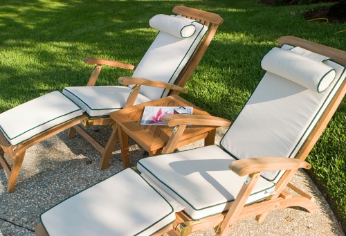 71081MTO Sunbrella Steamer Cushion in canvas with forest green Welt color on two Captain steamers with side table in between on grass field