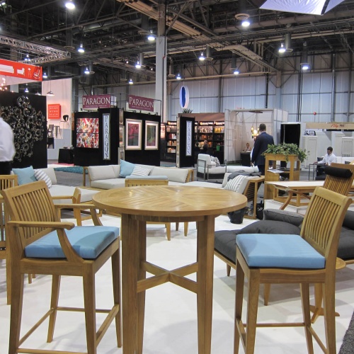 71910CV Laguna Side Counter or Bar Stool Seat Cushion on Laguna teak barstool showing 2 at a trade show in background