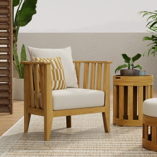 12170DP Kafelonia teak Barrel Chair with cushions back angle outside on concrete patio overlooking pool and ocean in background