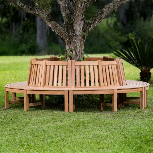 13691 Teak Tree Hugger Bench 5 sections around tree on grass with trees in background
