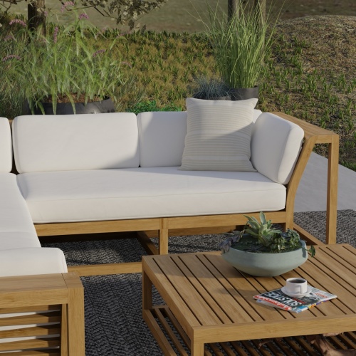 13801DP Maya Left Side Sectional Set with cushions front angle view on patio with shrubs in the background 