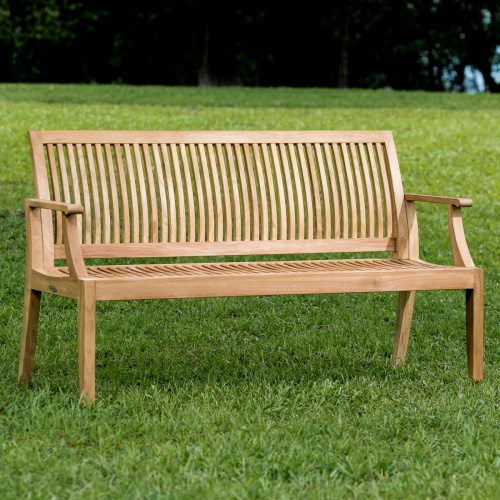 13811 Laguna 5 foot Teak Bench angled on grass in field and trees in background