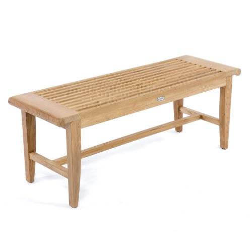 13916 Laguna teak backless bench in tiled bathroom shower with three folded towels back brush and plant on bench against window two towels on hooks toiletries in niche