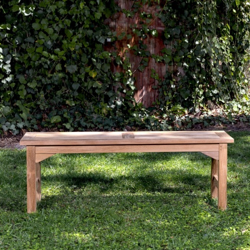 13940 Veranda 4 foot Teak Backless Bench angled aerial view on grass area with trees & shrubs in background