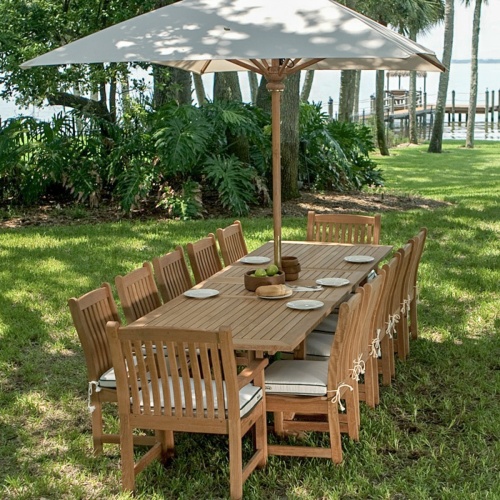 17640F Grand 10 feet Rectangular teak Umbrella in dining set bowl green apples bowls and place setting on lawn with brick house and trees in background 