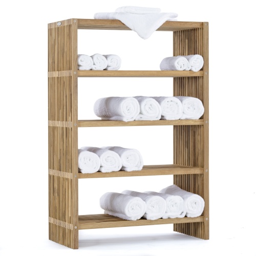 18221 Teak 48 inch Storage Shelf in angled aerial side view next to potted plants against a wall with a potted plant on top of shelf and folded towels on the lower shelves with ocean in back