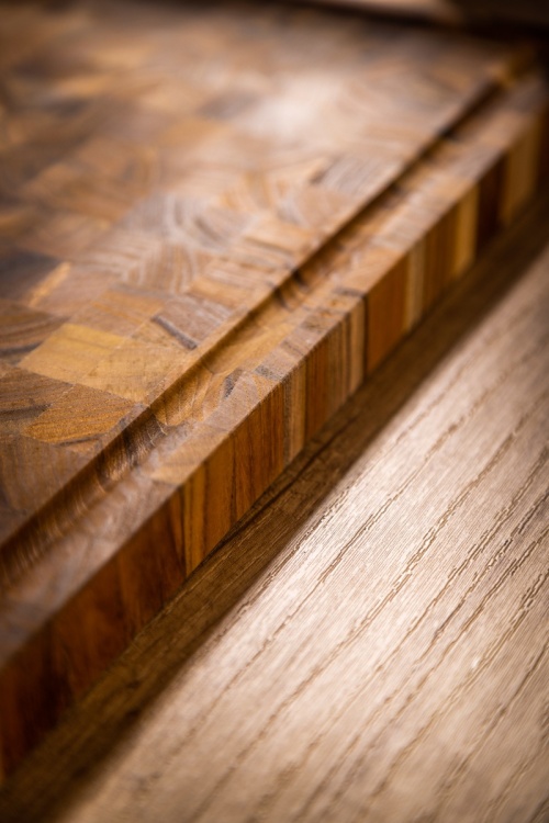 19124 Butcher Block 20 inch Rectangle Charcuterie Cutting Board showing closeup side view on a counter top