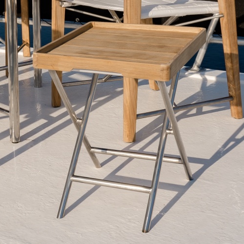 28815DP odyssey ottoman with serving tray on boat deck with Odyssey folding chair in background