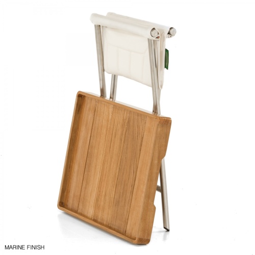 28815F Odyssey Folding Ottoman and teak serving tray in Marine finish leaning against folded ottoman on white background