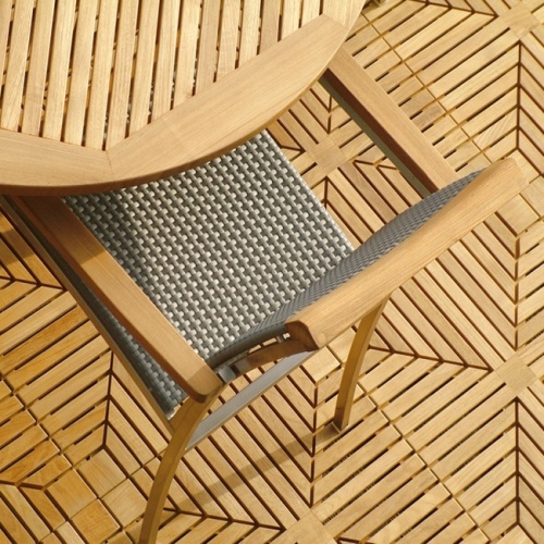 70030 Grand Hyatt round dining table and a SS Kelly dining chair showing aerial partial view on teak tile floor
