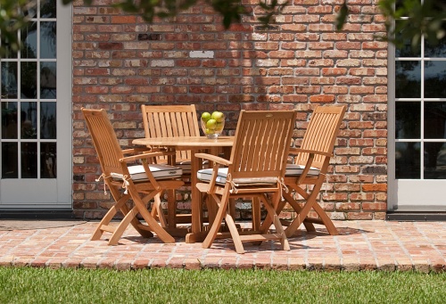 70066 Barbuda Round 5 piece Folding Dining Set on brick patio with house and french patio doors in background