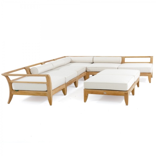 70101 Aman Dais 8 pc Daybed showing 2 corner sectionals and 4 end sectionals and 2 ottomans with cushions angled on wood deck with railing and ocean in background