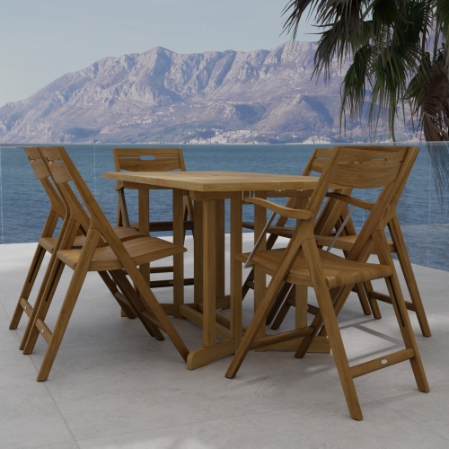 70146 Surf Nevis Teak 7 pc Dining Set of Nevis Dining Table and 2 Surf Dining Chairs and 4 Surf Side Chairs end view on tile patio overlooking the ocean and land mass in background