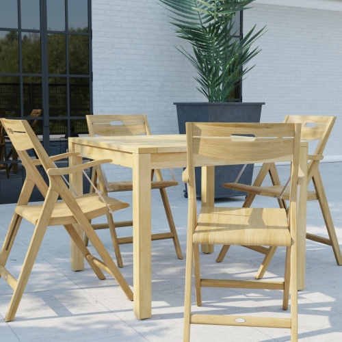 70147 Surf teak 36 inch square 5 pc Dining Set of 4 teak folding Dining Chairs and a teak 36 inch square dining table in angled aerial view on patio with pool and fence in background