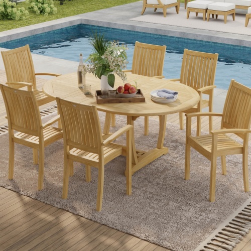  70214 Martinique Sussex Teak 7 pc Dining Set with optional seat cushions and umbrella in side view next to pool with blue sky in background