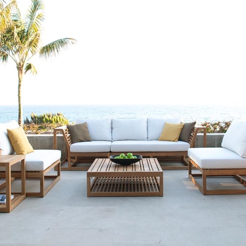 70232 Maya 6 piece Sofa Set with cushions and a blue throw pillow on sofa in front view on outdoor patio with staircase in background 