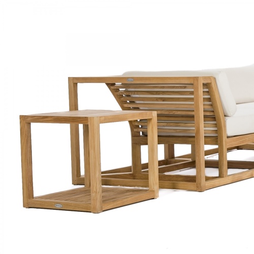 70233 Maya 7 pc Sectional Furniture Set in angled aerial view on a patio next to a pool with landscape plants and a privacy wall and door in the background