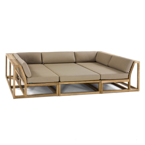 70274 Maya 3pc Daybed on patio in aerial angled side view with tray of fruit on middle daybed section facing a pool next to a potted plant with privacy wall with shrubs and trees in background
