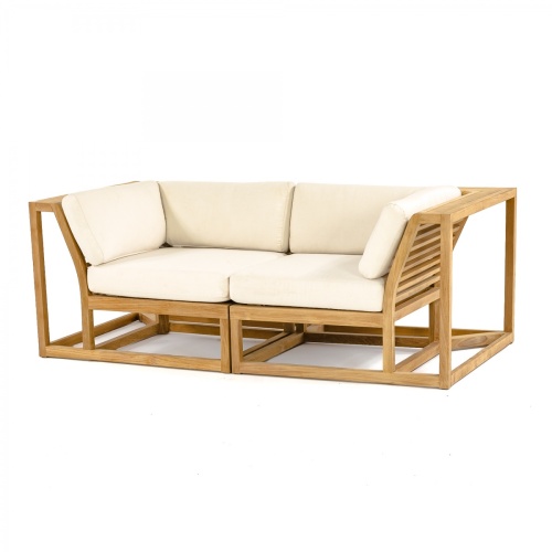 70275 Maya Love Seat of 2 Maya Corner Sectionals in angled end view on wood deck terrace with a plant and ocean and blue sky in the background