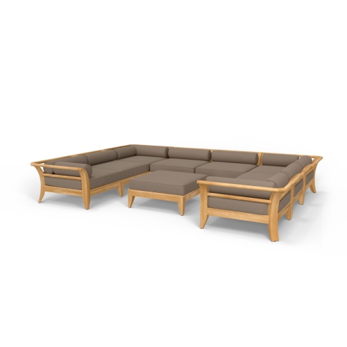 70282 Aman Dais 9 pc teak Daybed Sectional Set with bolsters and cushions angled aerial view on deck with pool and glass door of house and trees in background 