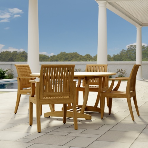 70305 Martinique 5 piece Dining Set angled end view on stone patio with 2 pillars of house with a plant and trees and privacy wall in the background  