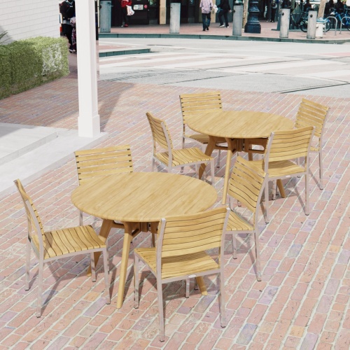 70825 Barbuda Surf 4 piece Dining Set showing 2 sets in angled aerial view on brick paver patio with road and people and cars in the background
