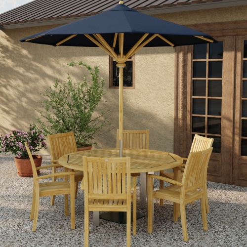 70358 Vogue Sussex 7 pc Dining Set with optional opened umbrella in table center in angled side view on patio with 2 potted plants next to window and french door in background