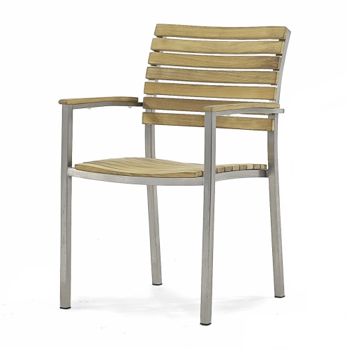 70442 Vogue Teak 7 pc Dining Set showing Vogue 60 inch Round Dining Table and 6 Dining Chairs angled aerial view on patio 4 potted plants against a house in background