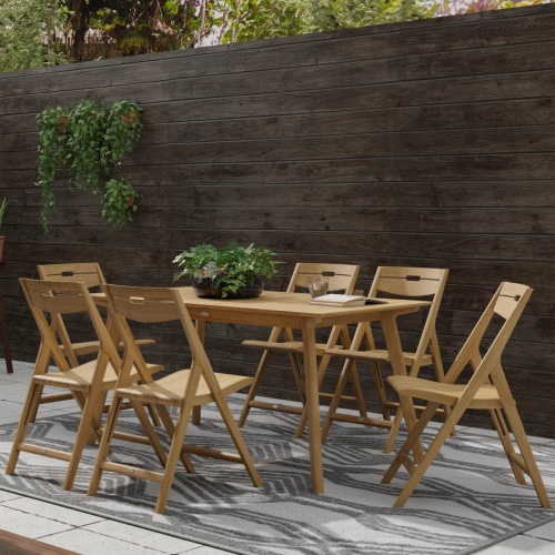 70518 Surf 7 piece teak folding Dining Set showing 3 Dining Sets in hospitality setting on patio with table settings and glasses and potted tree with ocean blue sky and land in background