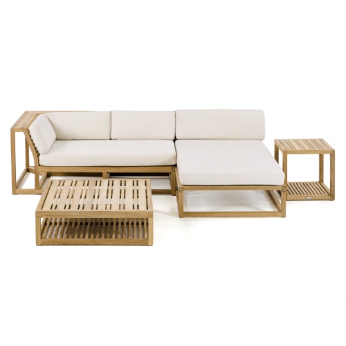 70658 Maya 4pc Lounge Set of Maya Right Side and Daybed Sectionals and Ottoman Coffee Table and Side Table  on patio against a wall in side view with ocean in background