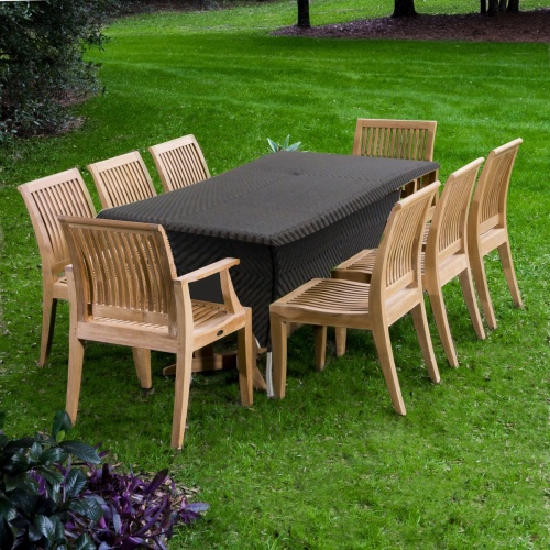 70294 Laguna Valencia 9 piece teak Dining Set of 2 Laguna dining chairs and 6 Laguna dining side chairs and Valencia synthetic wicker 79 inch rectangular table on grass with trees in back