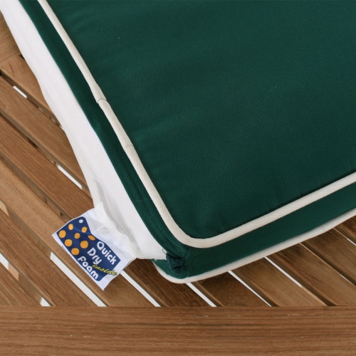71021MTO armchair cushion in forest green lying on a table